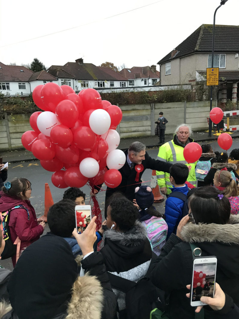 Barry handing out balloons to pupils 