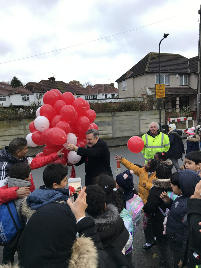 Barry handing out balloons to pupils 